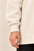 Jersey con cremallera lateral en albaricoque, detalle del puño