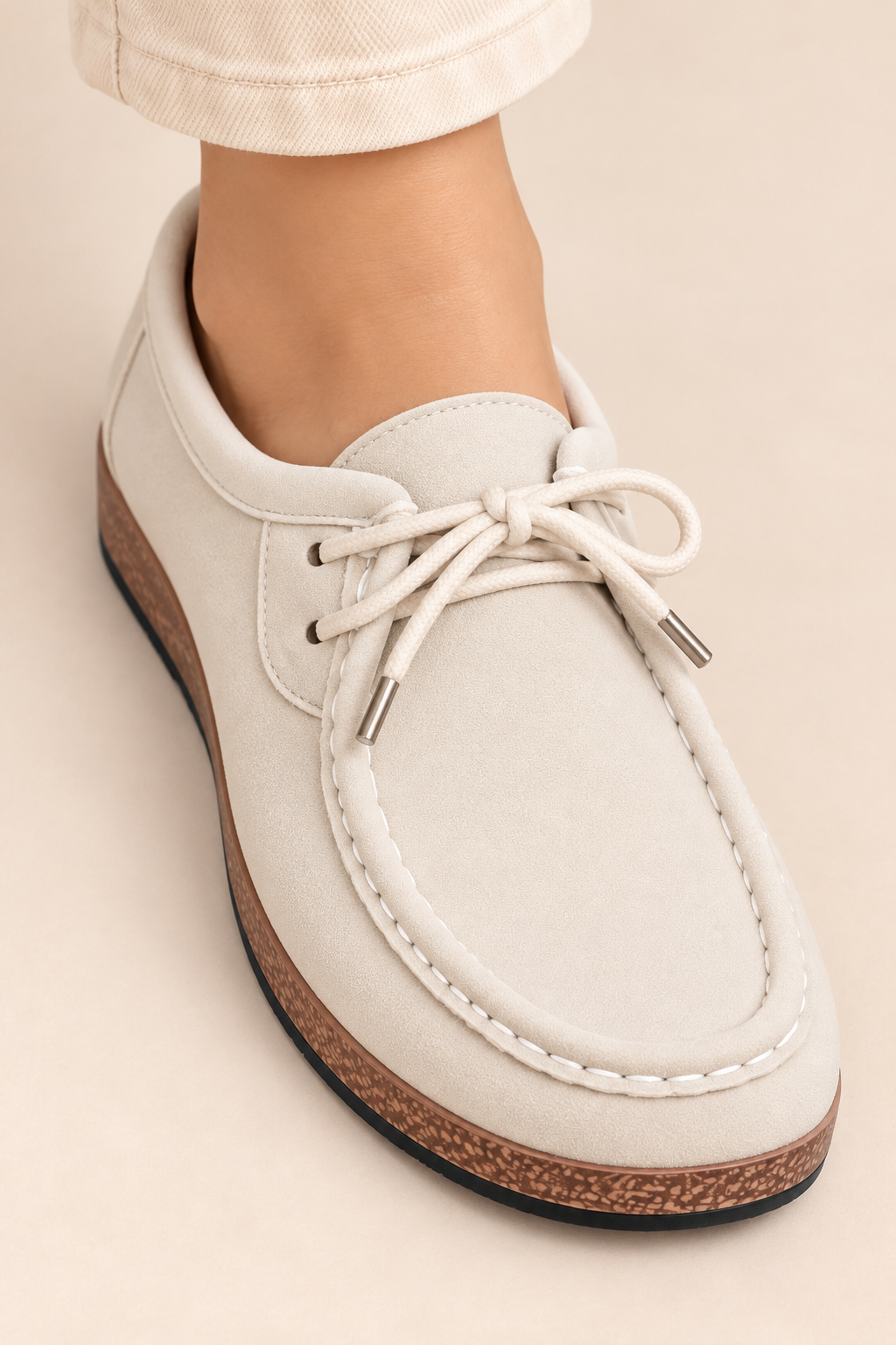 Mocasines de cordones con pespuntes en beige, detalle de los cordones y los pespuntes