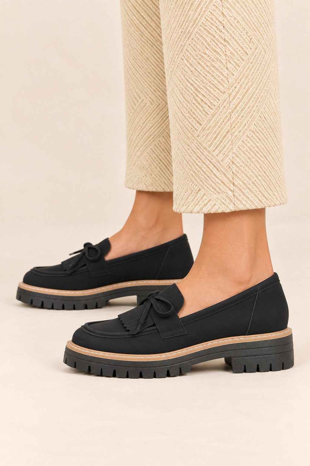 Mocasines con lazo y flecos en negro, vista lateral